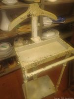 Full view of valet showing hanger, tray, legs and base