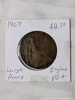 Front view of 1907 large penny in holder