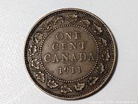 Reverse of 1911 Canadian one cent coin showing legend and maple wreath