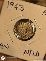 Front of holder showing reverse of coin with 5 CENTS 1943