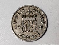 Reverse showing crowned GRI monogram, date 1948, denomination SIXPENCE