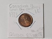 1989 Canadian 1-cent coin in holder, full view with handwritten notes