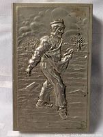 Front view showing full embossed sowing farmer design on lid