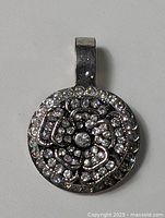 Front view of round CZ floral pendant
