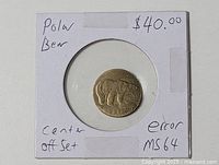 Full view of brass-coloured toonie core in 2×2 holder