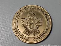 Obverse showing maple leaf and Grand Lodge A.F. & A.M. legend