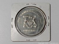Obverse showing Ontario coat of arms and centennial dates