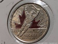 Close-up of obverse showing men’s hockey design and red maple leaf