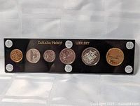 Front view of 6-coin proof-like set in holder