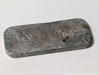 Top view of pewter ingot showing texture and shape