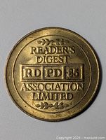Obverse side of brass Reader's Digest Association Limited token