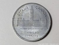 Front view of token showing Parliament building and inscriptions