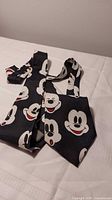 Front view of folded Mickey Mouse print necktie