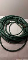 Coiled green extension cord overview