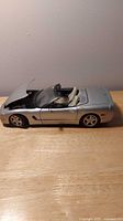 Left side view of silver 1:18 Corvette model