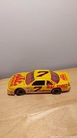 Side profile of yellow No.7 Mac Tools Buick model car