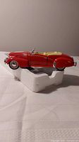 Side profile of red 1940 Cadillac convertible on Styrofoam block