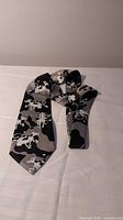 Full view of cow print silk necktie front