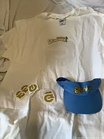 T-shirt, visor and tattoos laid out