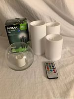 All items: boxed Noma solar lights, three flameless candles, glass votive with tealight, remote