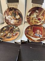 Group shot of four plates in front of original boxes
