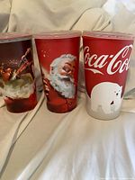 Front view of three holiday Coca-Cola cups