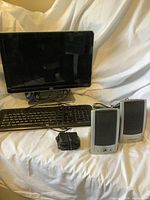Overall view of HP monitor, HP keyboard, Gateway speakers and power adapter