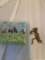 Dancing Tigger brooch and illustrated Pooh box exterior