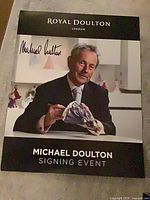 Front view of poster showing branding, printed signature and Michael Doulton image