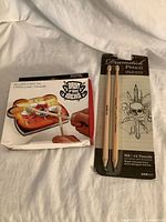 Front view of drum kit stationery set package and drumstick pencil package