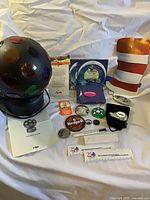 Full view of disco ball and assorted promotional items laid out on white surface