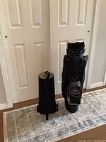 Bag standing collapsed next to separate view of wheel base