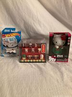 Front view of all three packaged Hello Kitty items