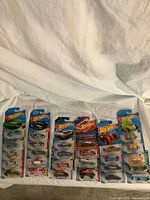 Row of sealed Hot Wheels blister cards laid out, showing overall quantity