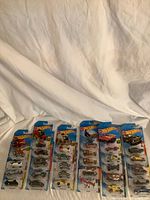 Group of 10 blister-card Hot Wheels cars laid out