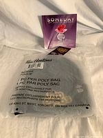 Front view of sealed TimBiebs beanie bag and Someday sample card