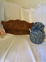 All three items: wooden 16-slot spoon rack, Joie Eggy egg timer in packaging, teapot inside blue patterned cozy