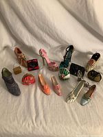 Group shot showing all 16 miniature shoes and handbags