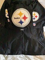 Front view showing large Steelers logo and NFL shield