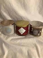 Three three-wick candles with lids