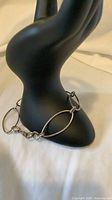 Bracelet draped on display hand showing full length and oval links