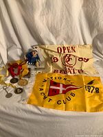 Full lot showing flags, medals, buckles, keychain and figurine