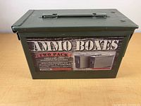 Olive drab steel ammunition can with marketing sleeve, top handle and front latch visible