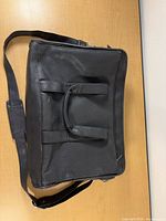 Full view of black leather laptop briefcase with strap and handles