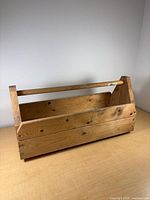 Front view showing open compartment and dowel handle