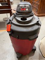 Front view of Shop-Vac showing brand label, 3.0 HP rating, cord, tank, wheels