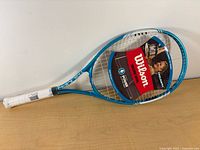 Full racquet showing frame, strings, hangtag