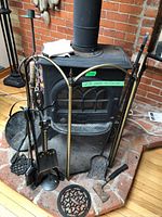 Overall view of screen, tool set, firewood on hearth