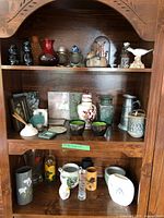 Overall view of three shelves showing majority of items in lot