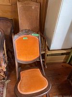 Adult upholstered rocking chair front view with child cane rocker behind